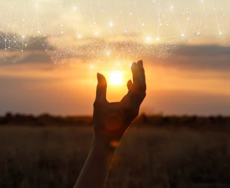 Hands raised toward the sunrise during a spiritual healing and energy wellness practice